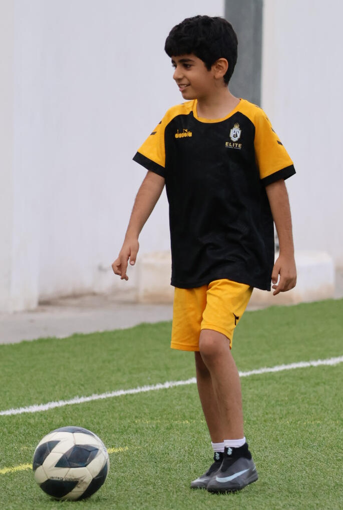 Confident boy at Elite Football Academy in Seeb